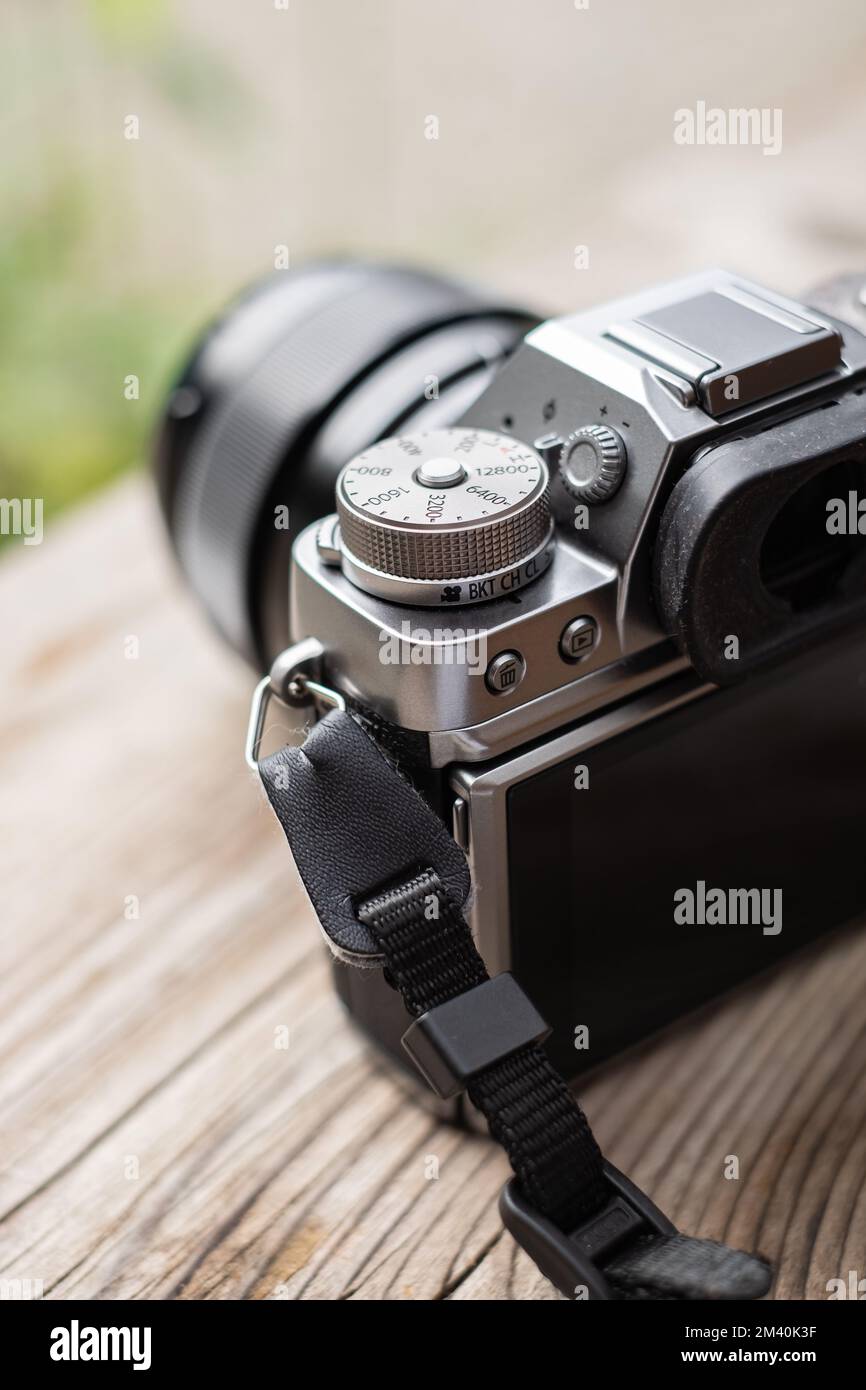 Digital camera mirrorless camera ready for take a photo. Modern MILC camera shooting outdoors photography. Nobody, selective focus, blurred background Stock Photo
