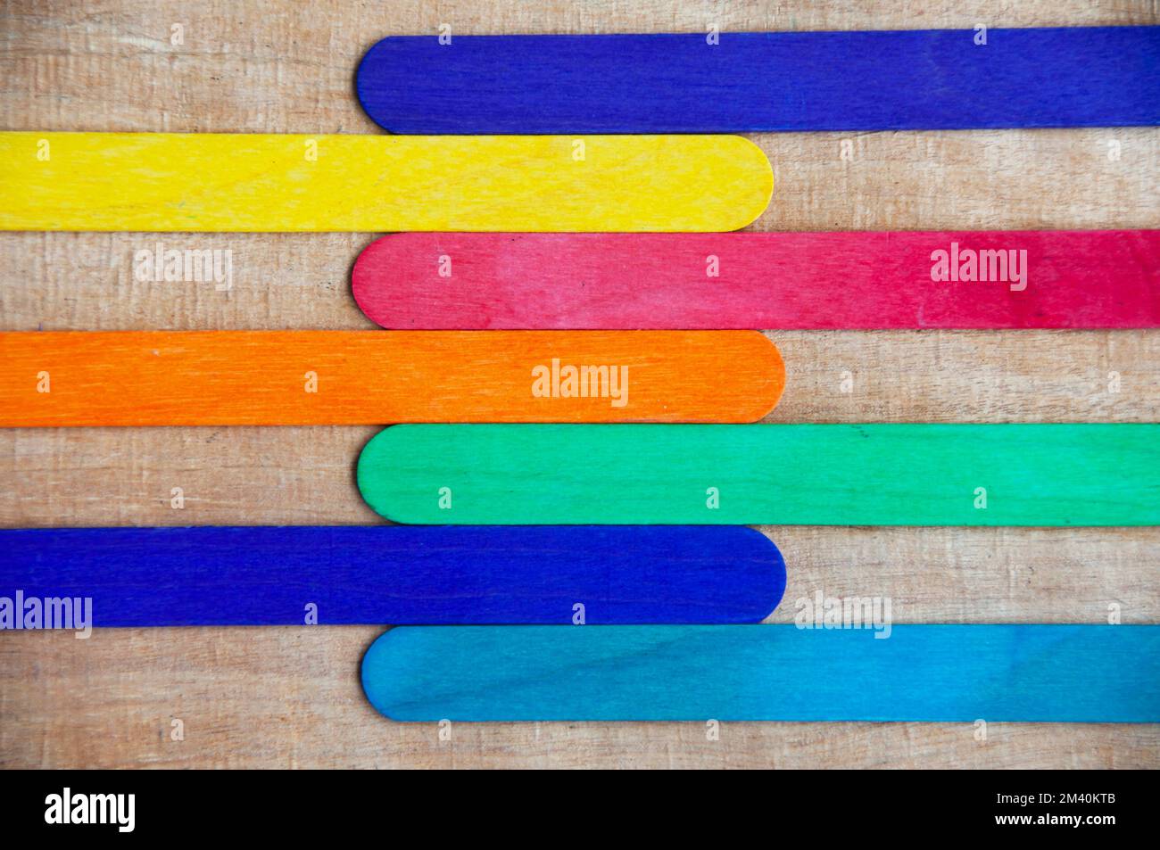 Top view of colored wooden sticks with customizable space for text. Copy space and color background concept. Stock Photo