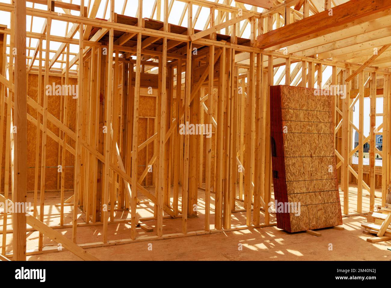 House under construction is framed with beams. Stock Photo