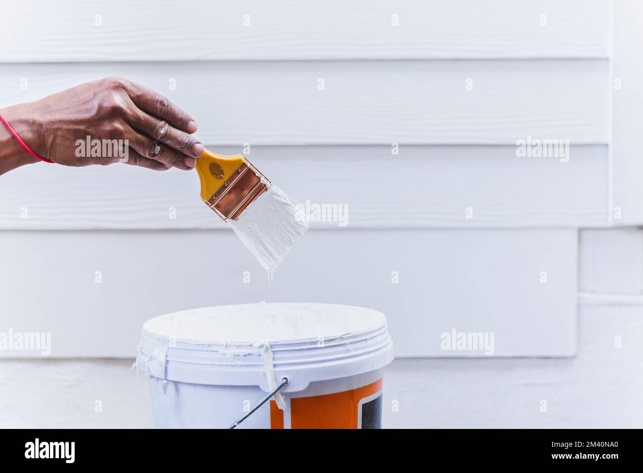 Painter hand holding paint brush with white paint Stock Photo Alamy