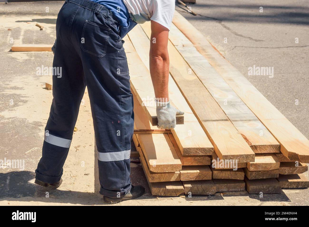 Work at sawmill on summer day. Timber harvesting for construction