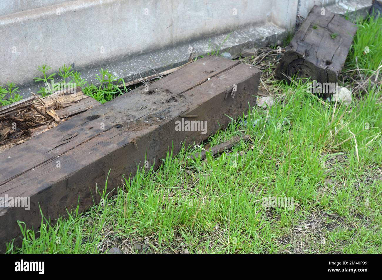 Large old wood that has dried up over time and from wear. It served and was used on the old railway track, lay under the metal ruts. Stock Photo