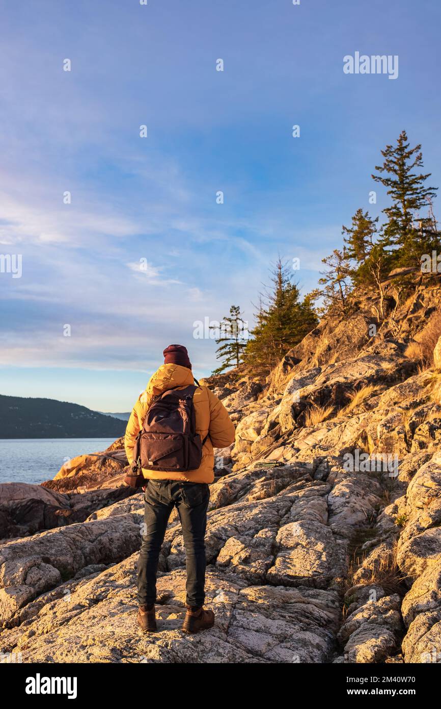 Active hiker enjoying the view. Male backpacker enjoying the view on mountain walk. Travel Lifestyle wanderlust adventure concept vacations outdoor al Stock Photo