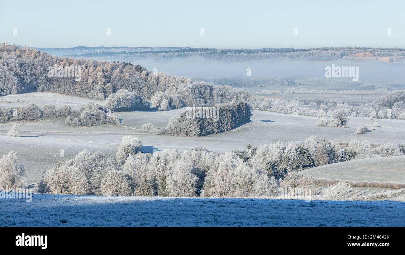 Winter Landscape: Hoarfrost on trees, fields and meadows in the low mountain range Eifel in Germany, Europe. Stock Photo