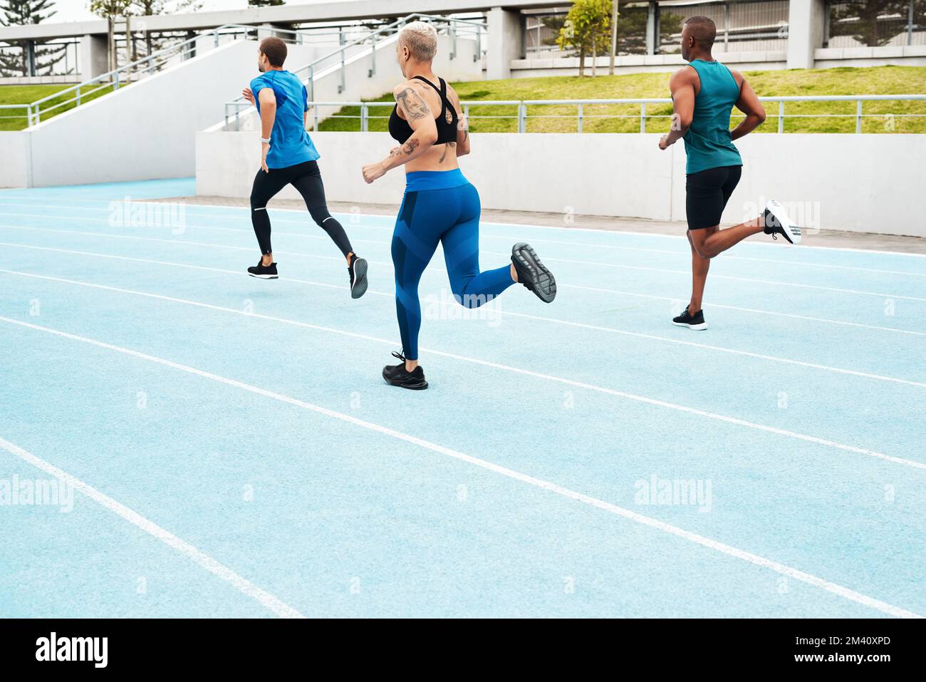 No pain no gain. Full length shot of a diverse group of athletes racing each other during an outdoor track and field workout session. Stock Photo