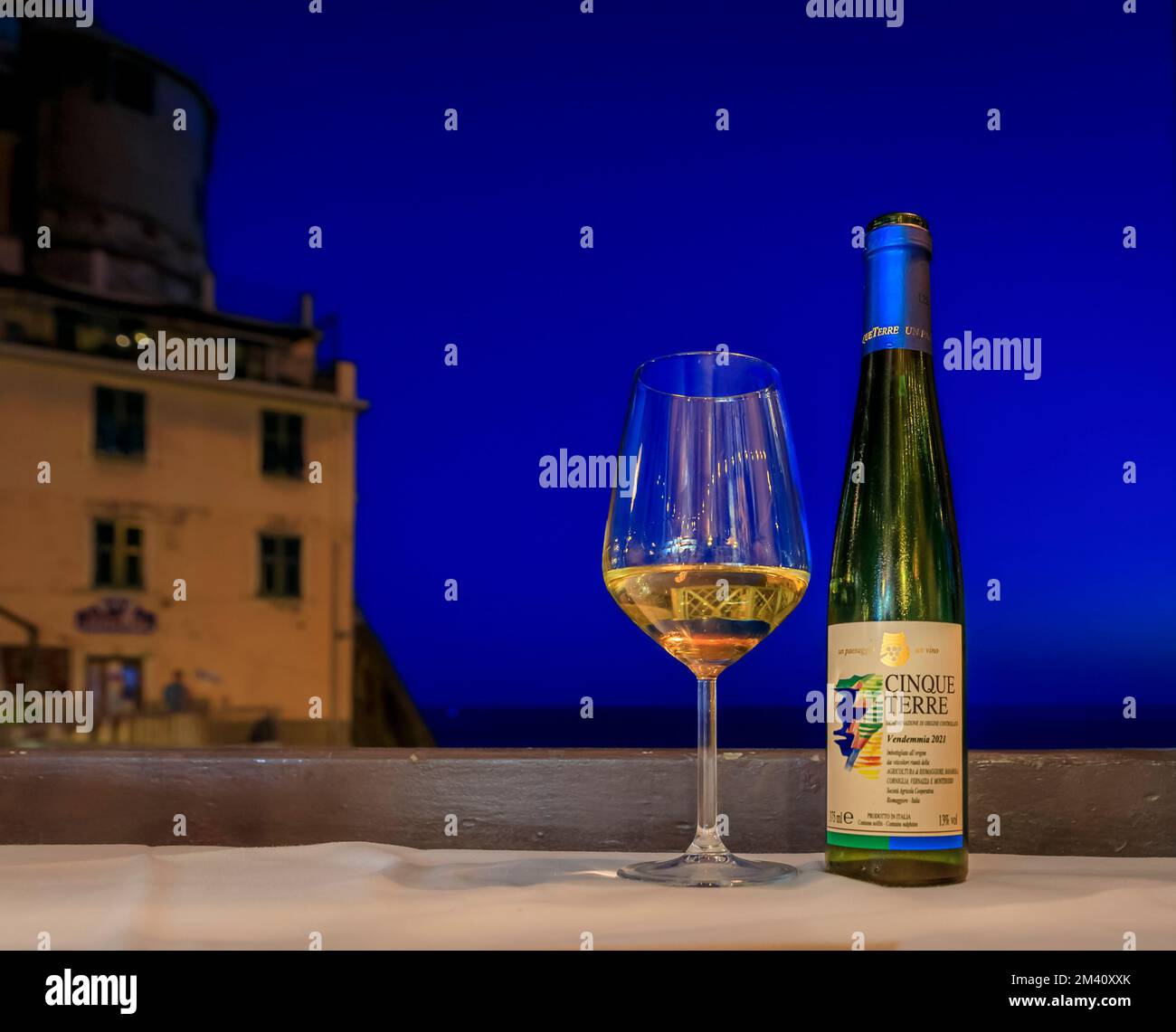 Manarola, Italy May 31, 2022 Bottle and glass of traditional Cinque