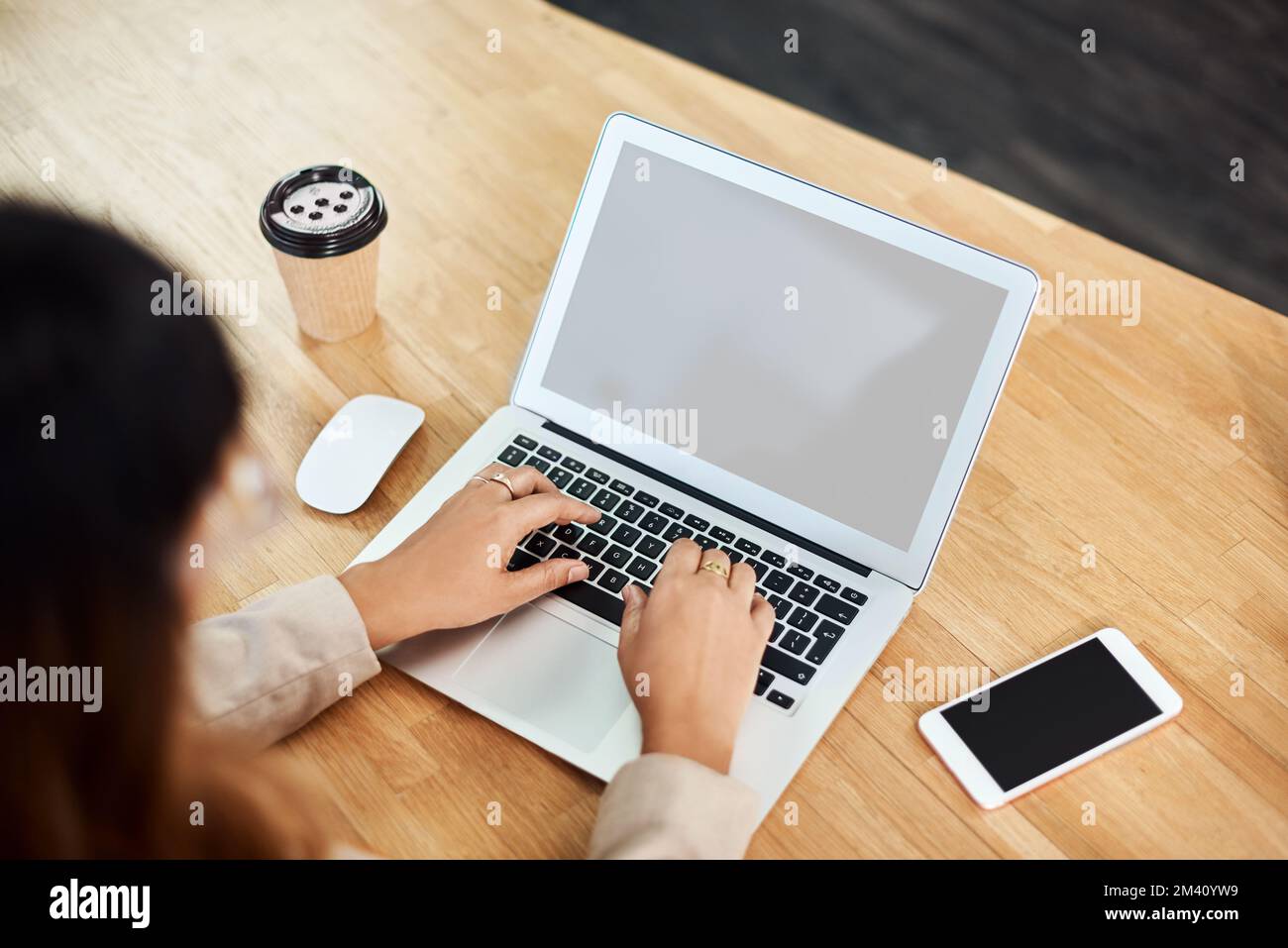 The work you put in never goes unnoticed in business. an unrecognizable businesswoman working on a laptop on her office. Stock Photo