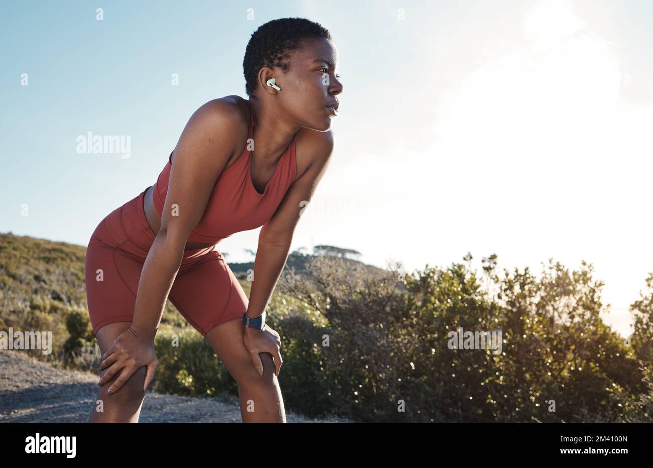 Black woman, tired or nature fitness break and music earphones for workout, training or exercise motivation. Fatigue, exhausted or breathing sports Stock Photo