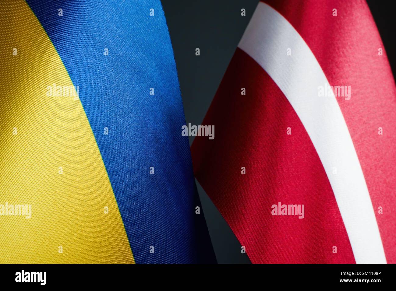 Flags of Ukraine and Latvia as a symbol of cooperation. Stock Photo