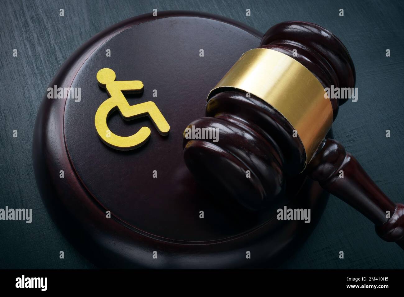Disabled person sign and gavel. Accessibility law concept. Stock Photo