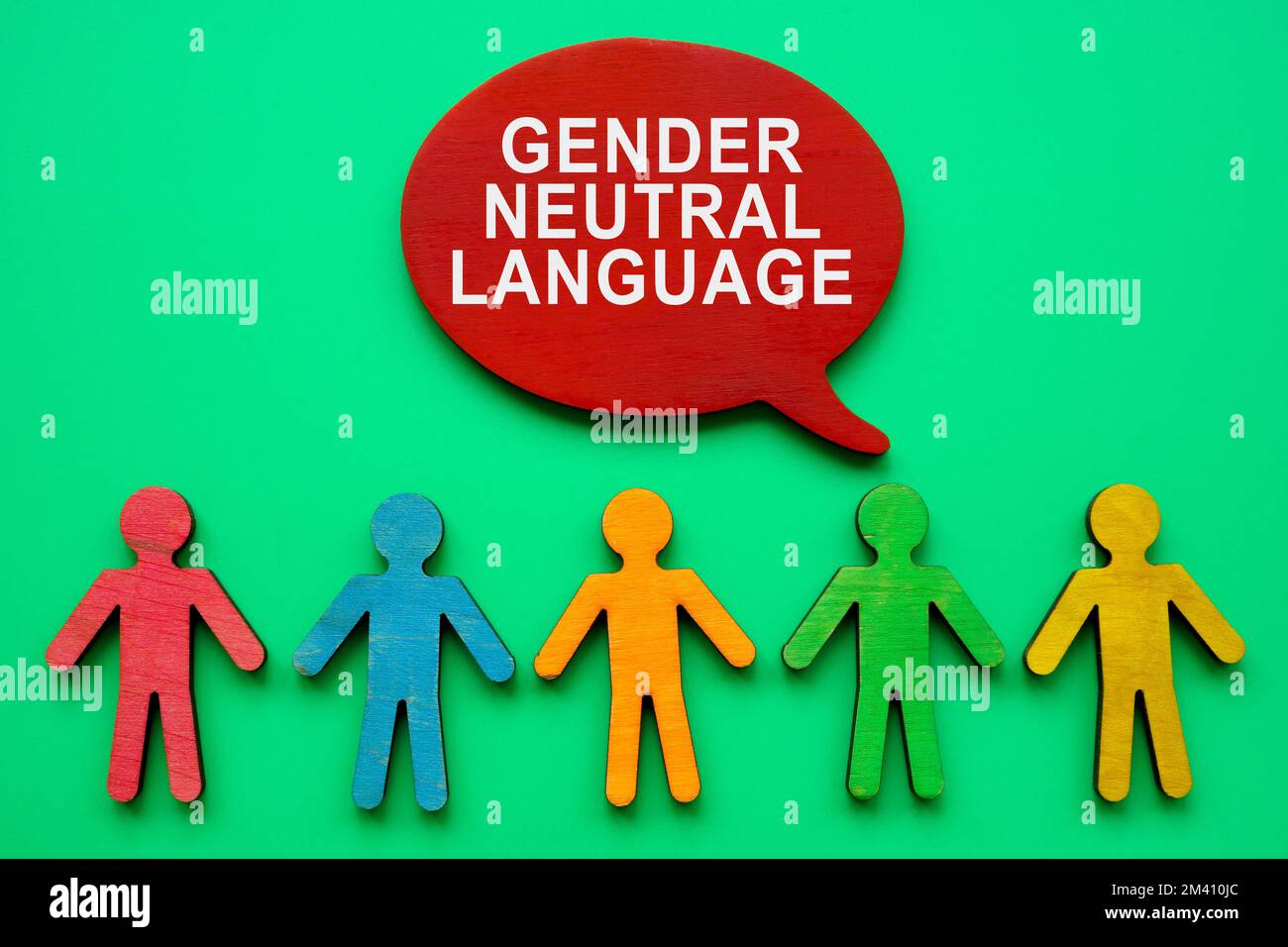 Gender neutral language inscription and colorful figurines. Stock Photo