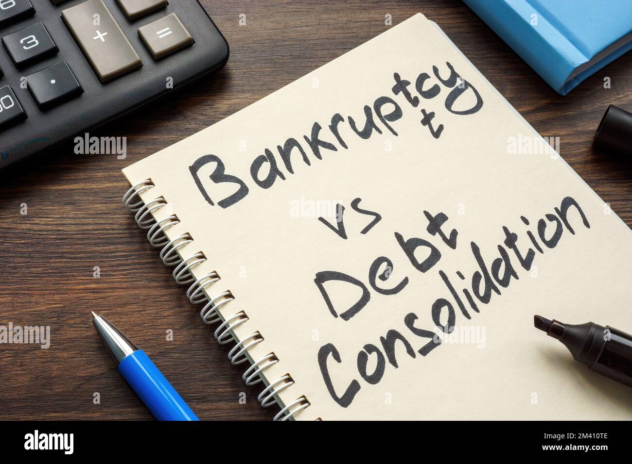 Page of a notepad with an inscription Bankruptcy vs debt consolidation. Stock Photo