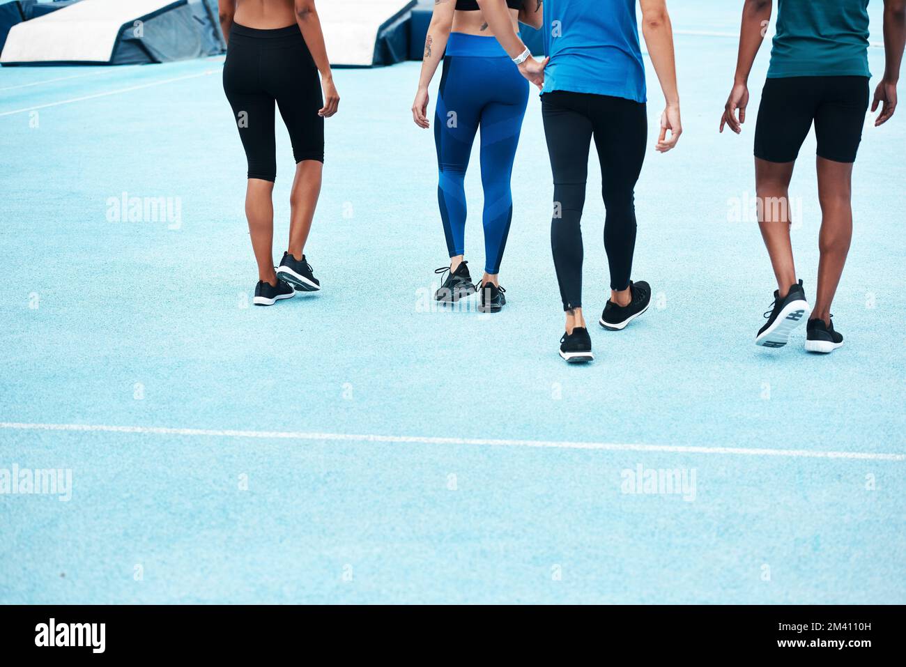 Fitness is our favourite habit. an unrecognizable group of athletes walking together after a running race on a track field. Stock Photo