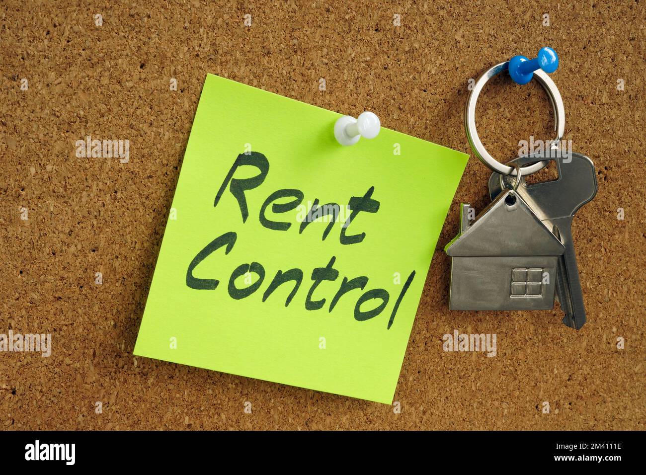 Key and sticker with inscription rent control pinned to the board. Stock Photo