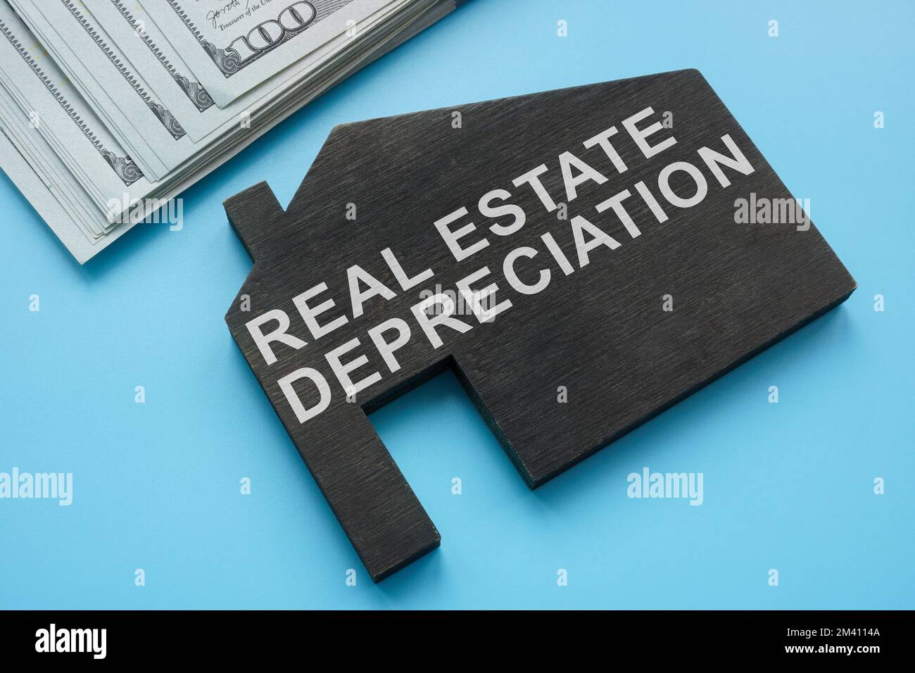 Real estate depreciation sign on the model of house. Stock Photo