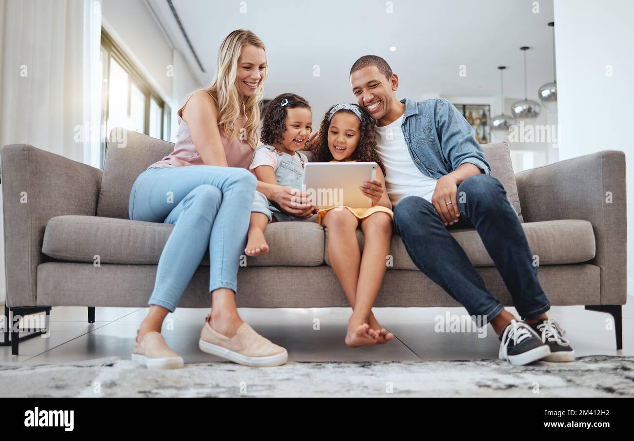 Happy family, tablet and sofa with children for movie, games and online video watch together with love, care and home education in living room Stock Photo