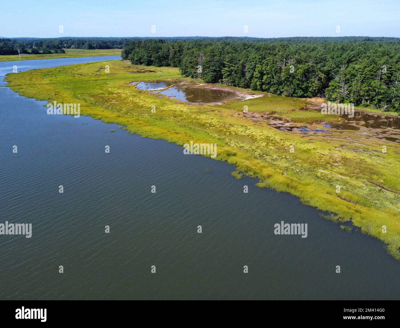 An aerial view of a river in the green field Stock Photo - Alamy
