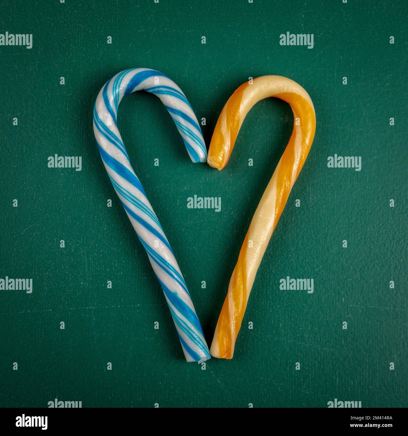Candy canes on a green chalkboard. Christmas and holidays concept. Stock Photo