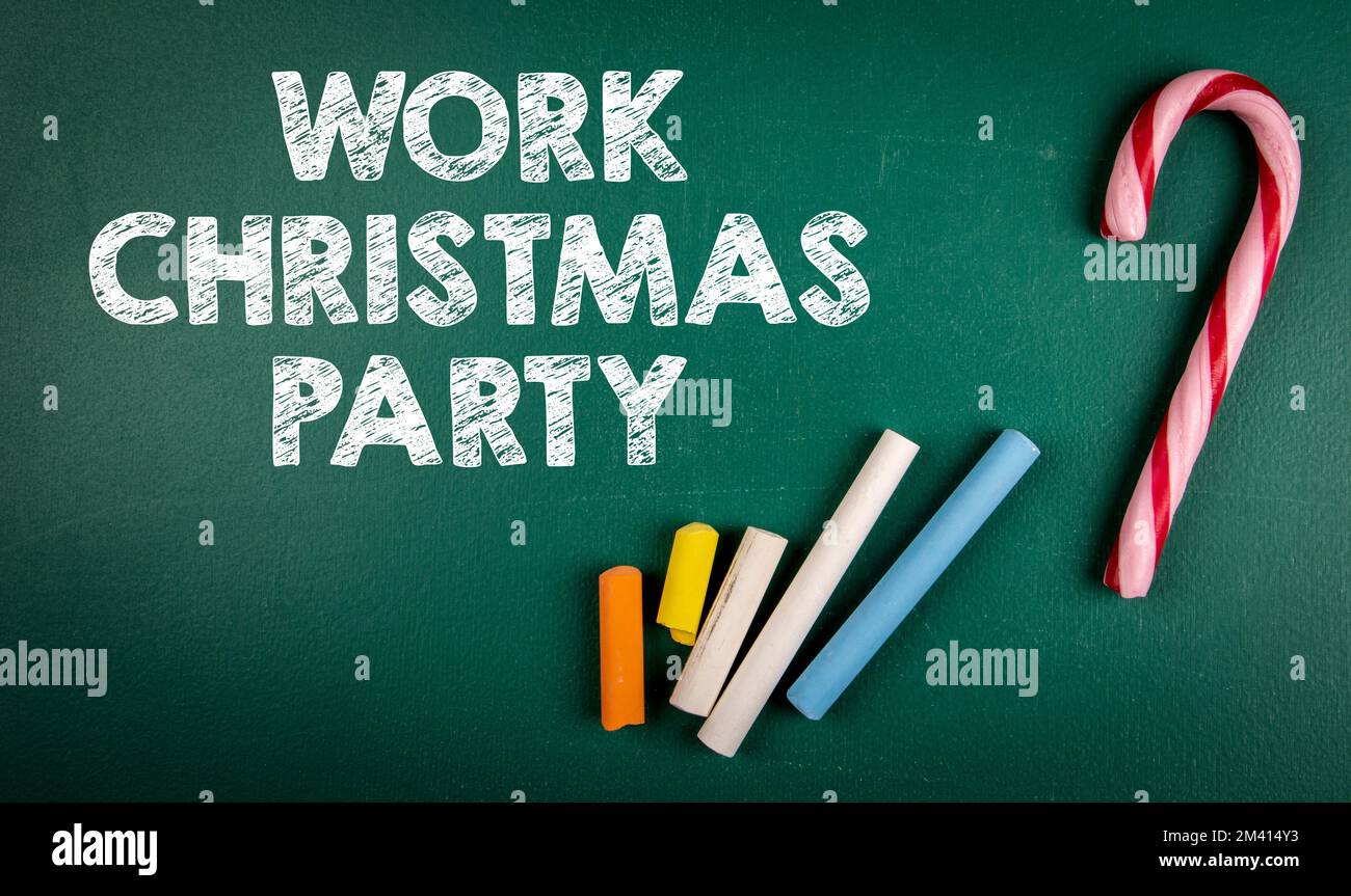 Work Christmas Party. Text and colored pieces of chalk on a green chalkboard. Stock Photo
