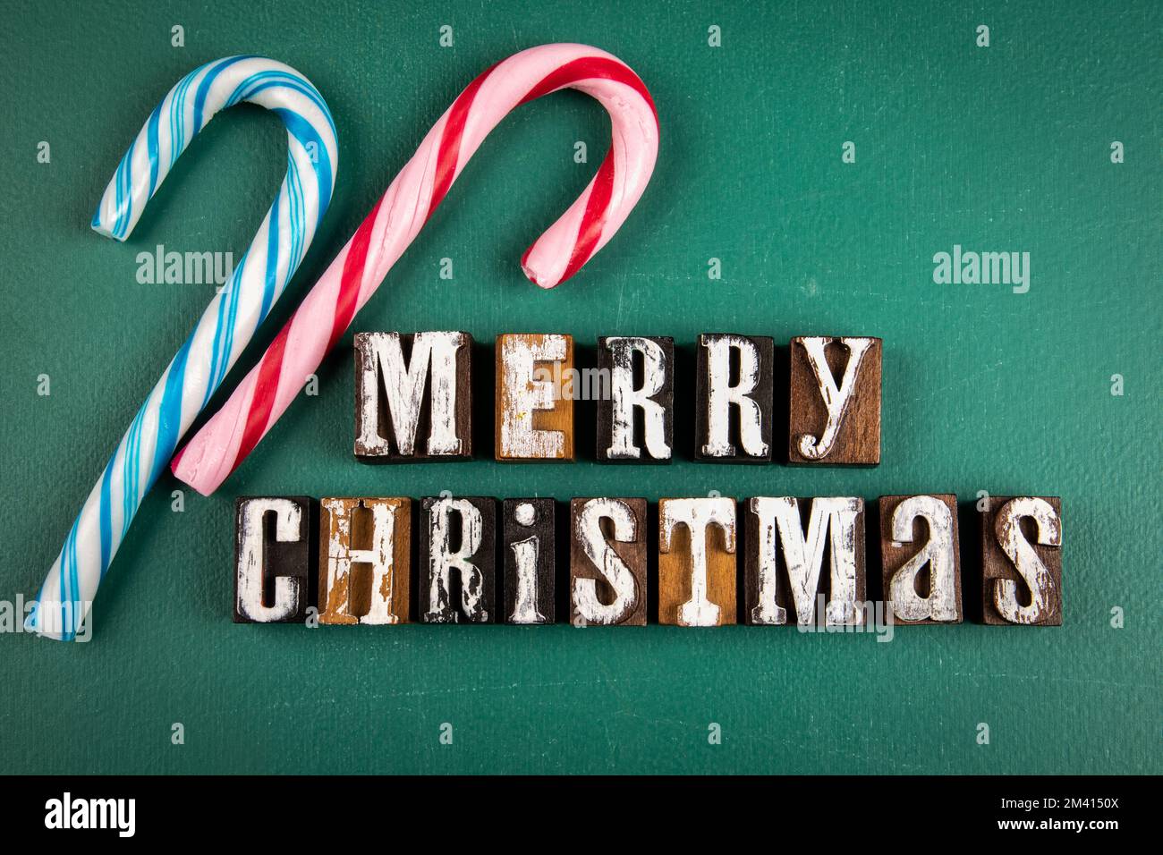 MERRY CHRISTMAS. Bequest text on a dark green chalk board. Stock Photo