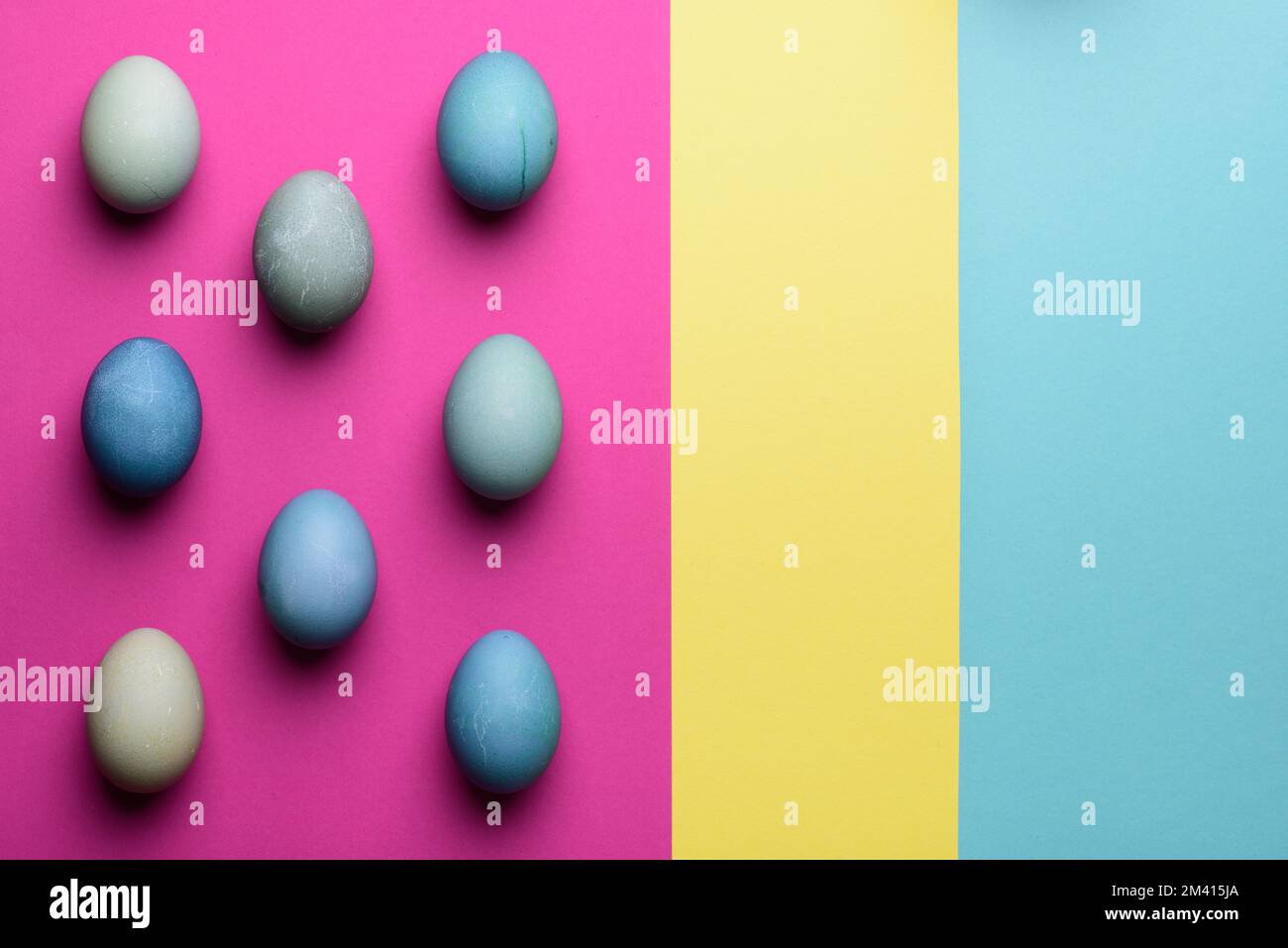 Happy Easter pastel coloured background. Hand painted Easter eggs abstract minimal concept. Stock Photo
