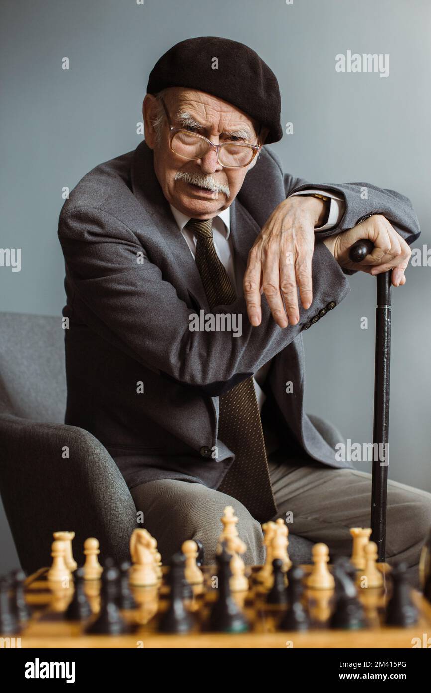 A Man Is Playing Chess Thinking About The Next Move Stock Photo - Download  Image Now - iStock