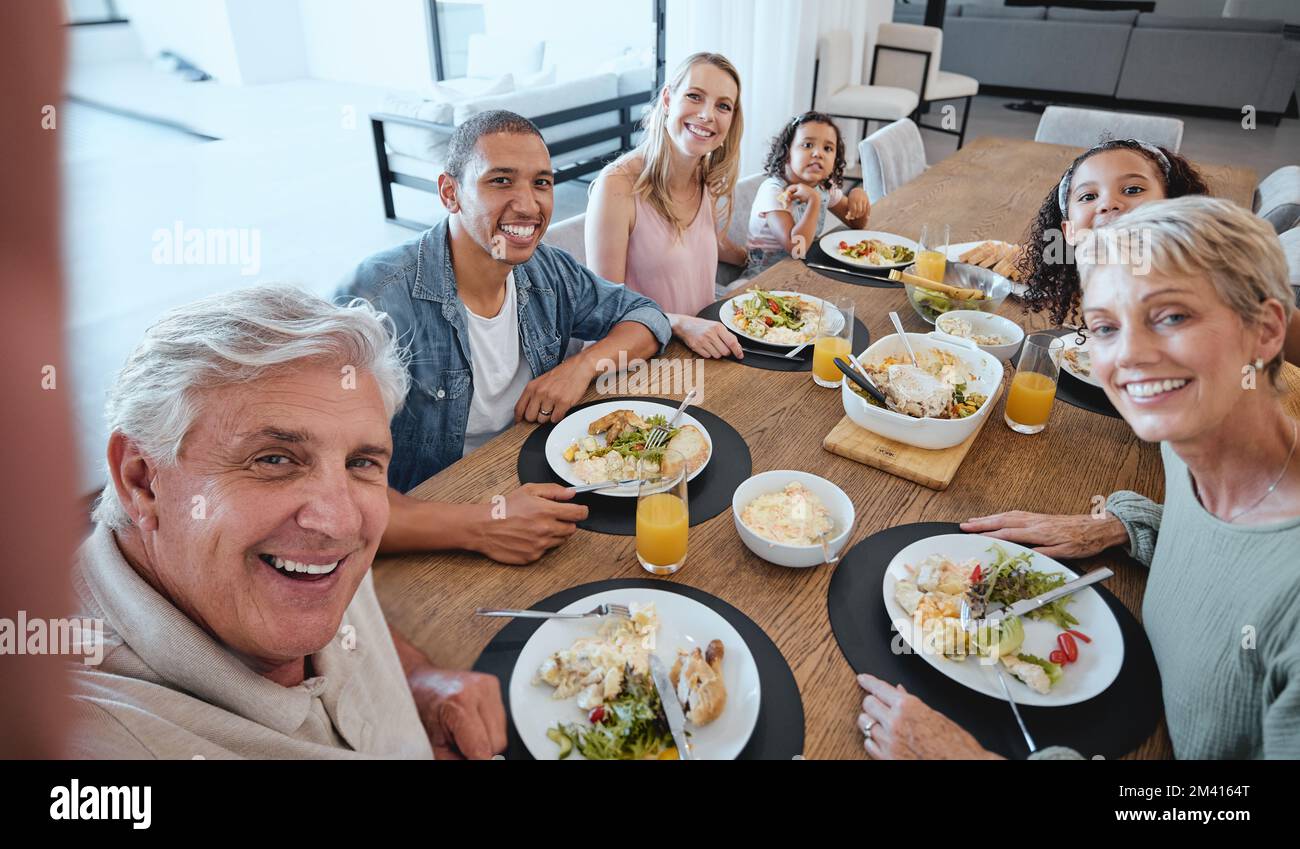 Big family, lunch and selfie with food on table in home dining room. Fine dining, happy memory and grandma, grandpa and father, mother and girls with Stock Photo