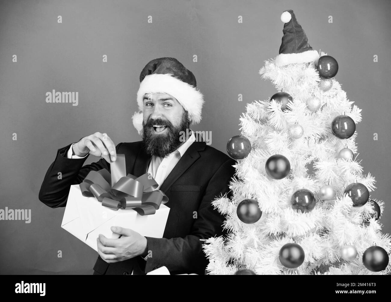 Winter holidays. Boxing day. Christmas party. Sharing kindness and happiness. Prepare gifts for everyone. Man bearded hipster formal suit christmas Stock Photo