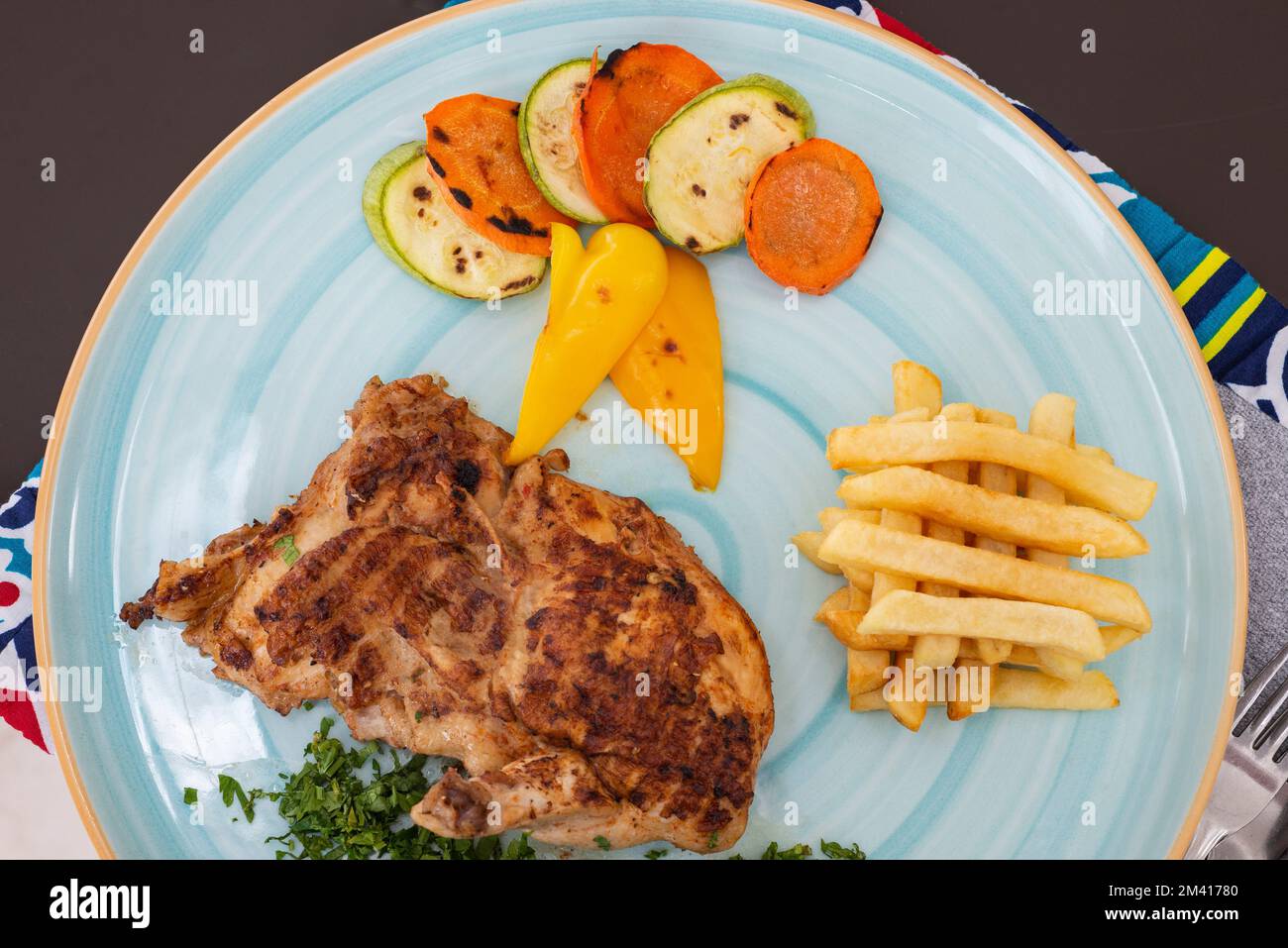 Beef steak a la carte meal with french fries chips and vegetables at