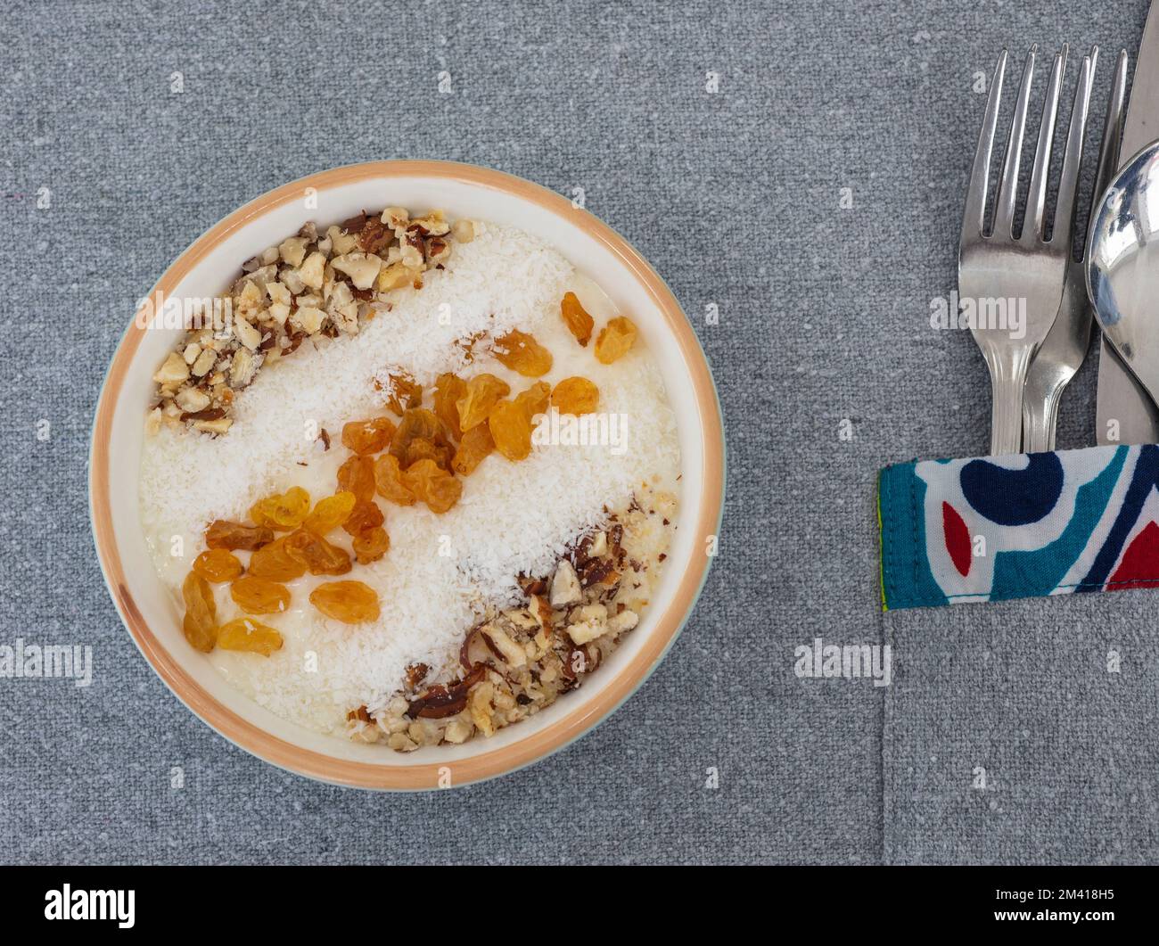 Rice pudding  la carte dessert meal with coconut flakes and sultanas on top Stock Photo