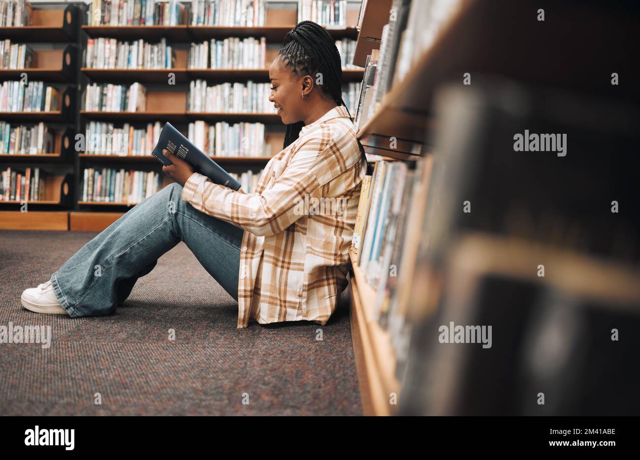 Bookshelf, library book and black woman reading, learning education and