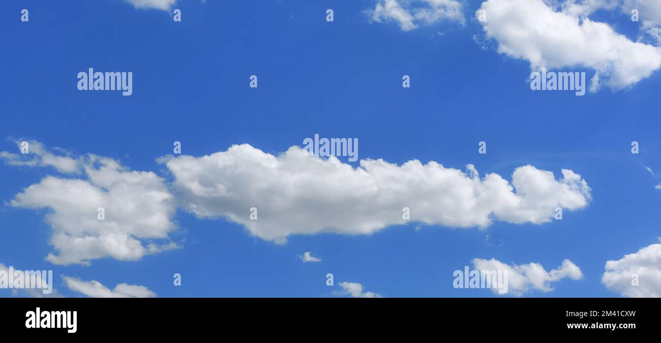 Fragment of the sky in summer with white clouds in good weather Stock Photo