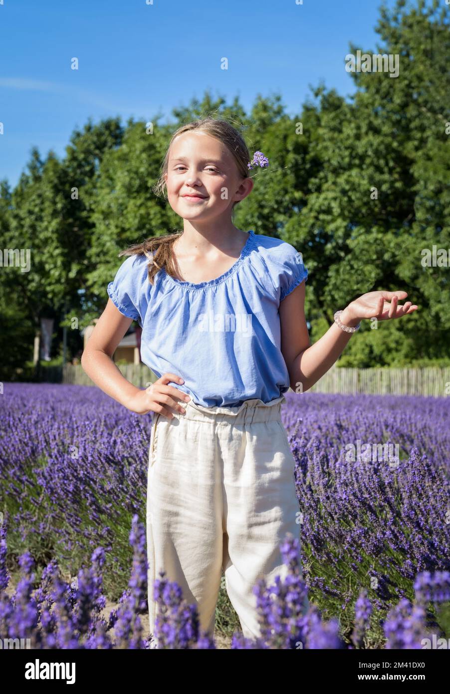 Portrait of young teen girl in lavender field. Happy teen with long ...