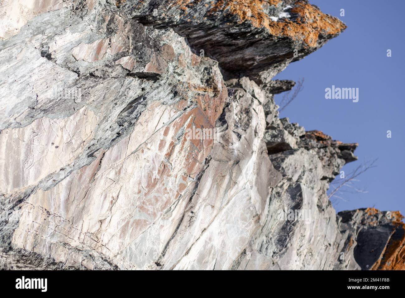 Old rock carvings of an ancient man on rocks in Siberia. The drawings ...