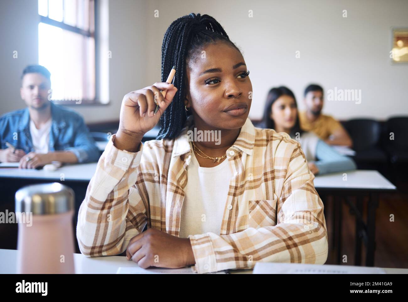 Education, university and black woman thinking in classroom, learning and listening during a lecture. Students, college and girl with vision for Stock Photo