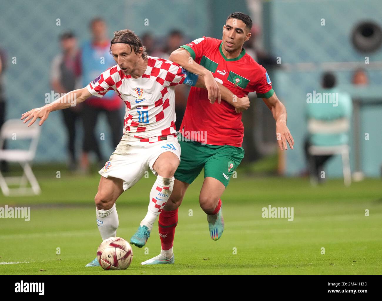 DOHA, QATAR - DECEMBER 17: Luka Modric of Croatia competes for the ball with Achraf Hakimi of Morocco ,during the FIFA World Cup Qatar 2022 3rd Place match between Croatia and Morocco at Khalifa International Stadium on December 17, 2022 in Doha, Qatar. (Photo by MB Media) Stock Photo