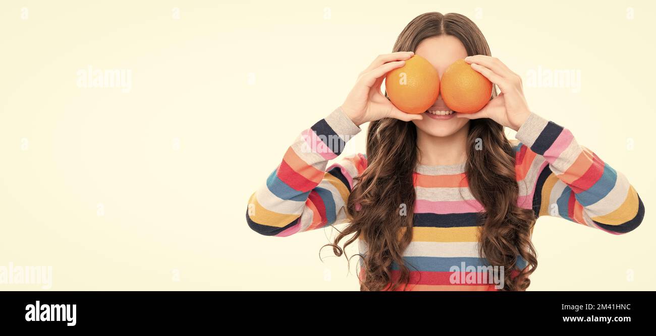 look. vitamin and dieting. child eating healthy food. childhood health. citrus fruits. Child girl portrait with orange, horizontal poster. Banner Stock Photo