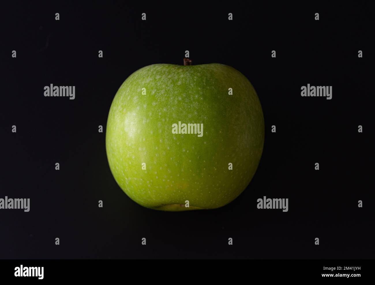 Green apple on a black background. Close-up Stock Photo