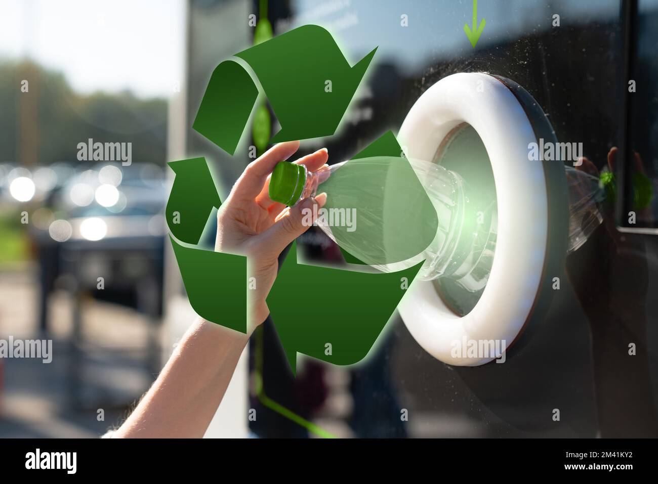 Woman uses a self service machine to receive used plastic bottles and cans on a city street . Recycling symbol Stock Photo