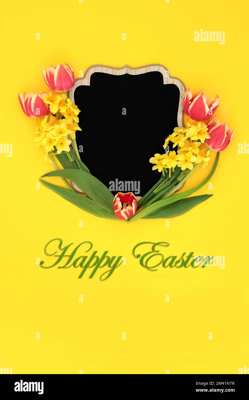 Happy Easter tulip and narcissus flower wooden frame with chalkboard on yellow background. Spring and Mothers Day creative nature floral border Stock Photo