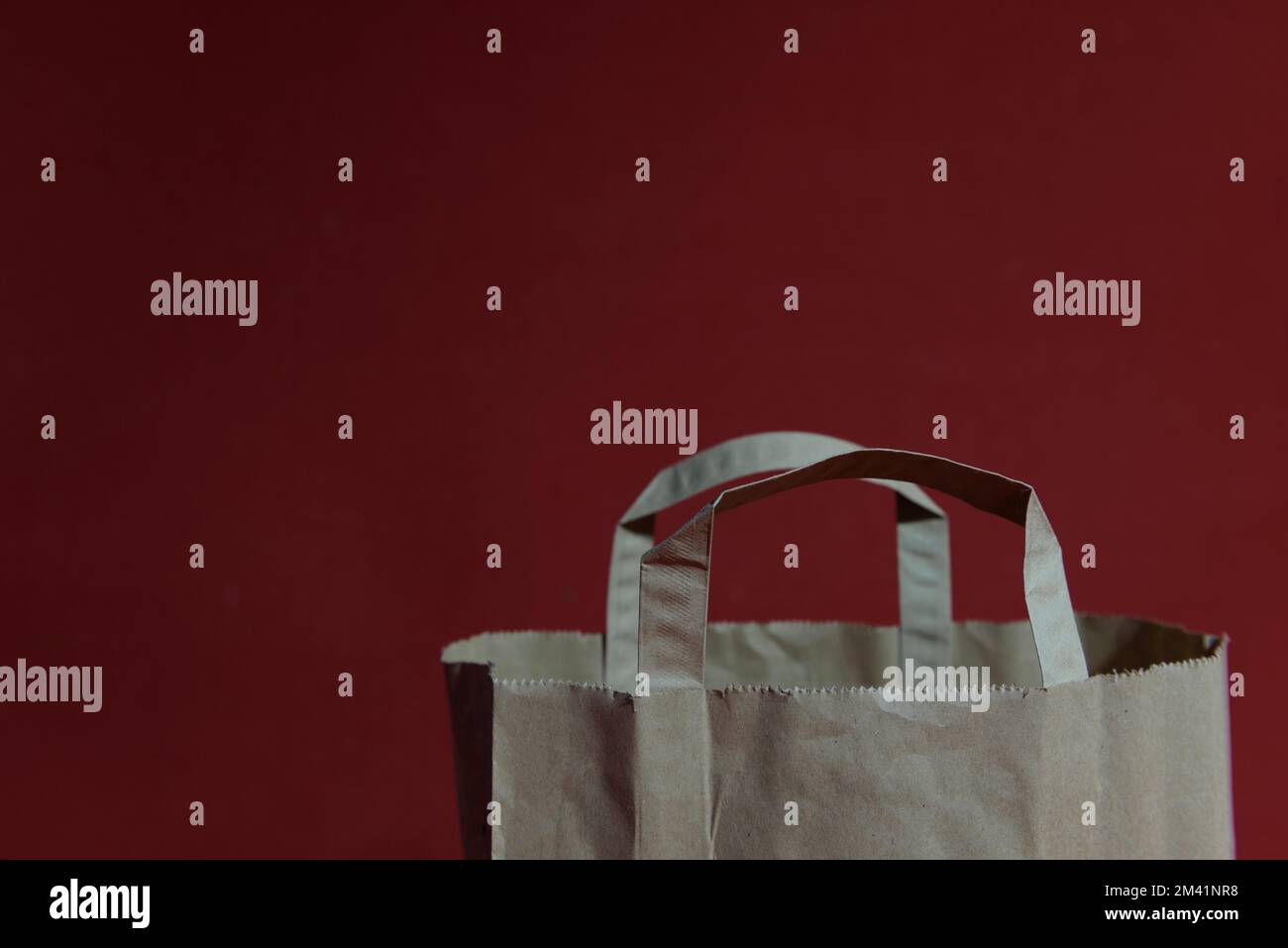 Paper shopping bag on a red background. copy space Stock Photo