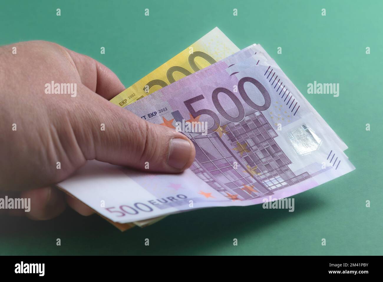 Banknotes in Euros. A close-up shot. Background of green Stock Photo ...