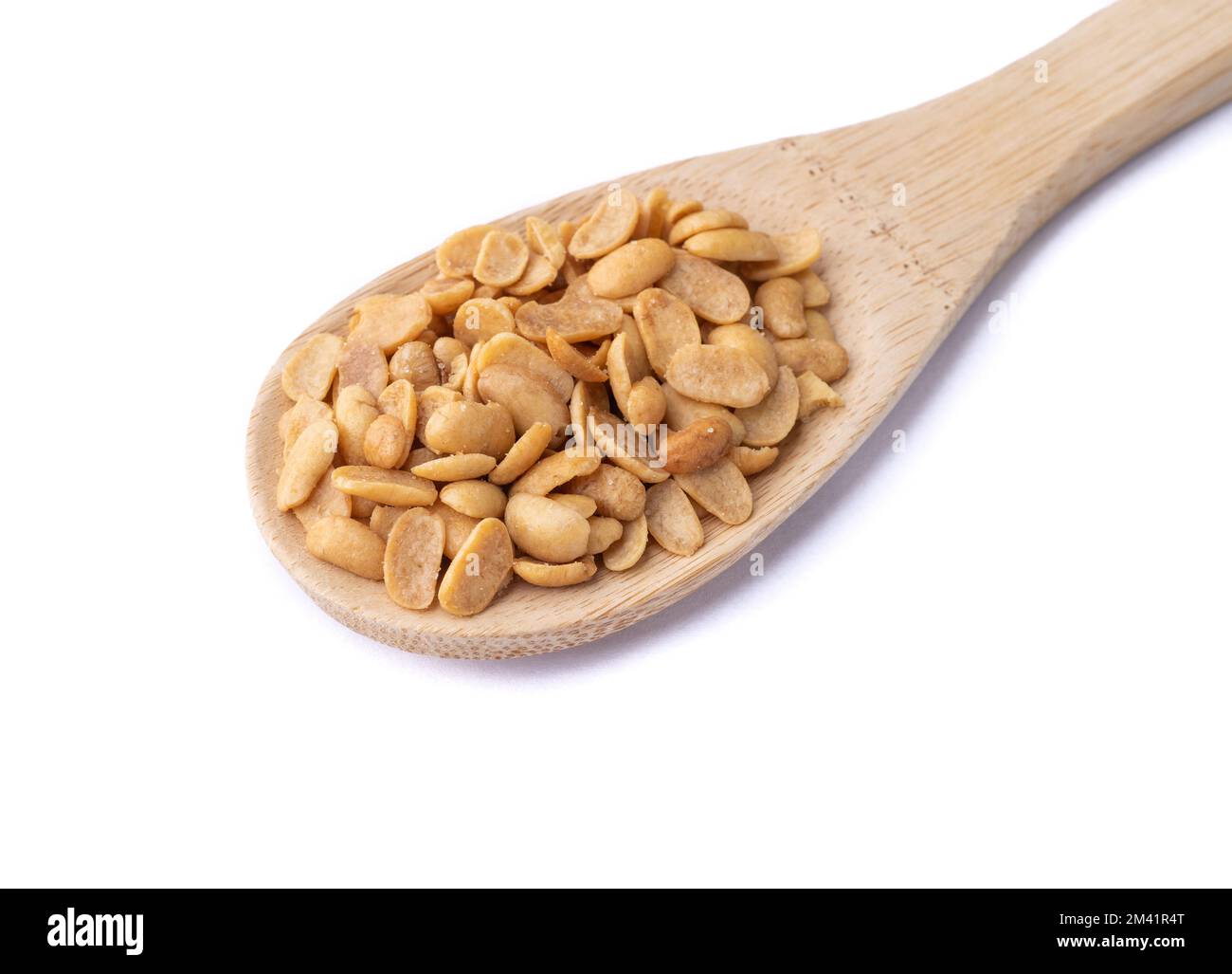 Fried soy beans snack in a spoon isolated over white background Stock