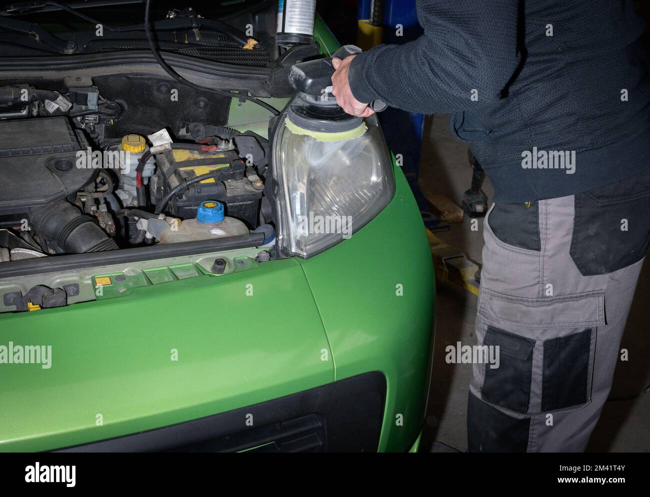 Polishing old car headlights. Car service worker with electrical