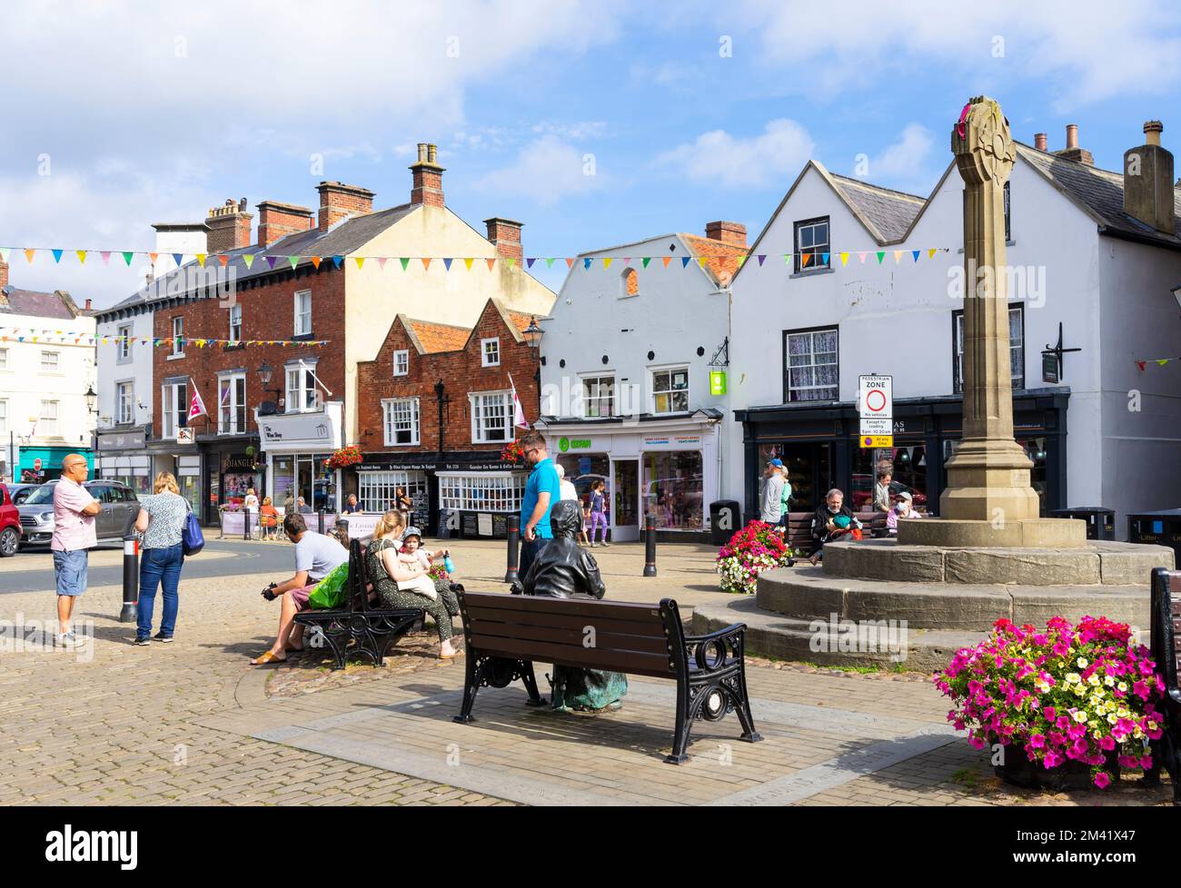 Knaresborough North Yorkshire People sat by the War memorial in Knaresborough Market Place Knaresborough Yorkshire England UK GB Europe Stock Photo