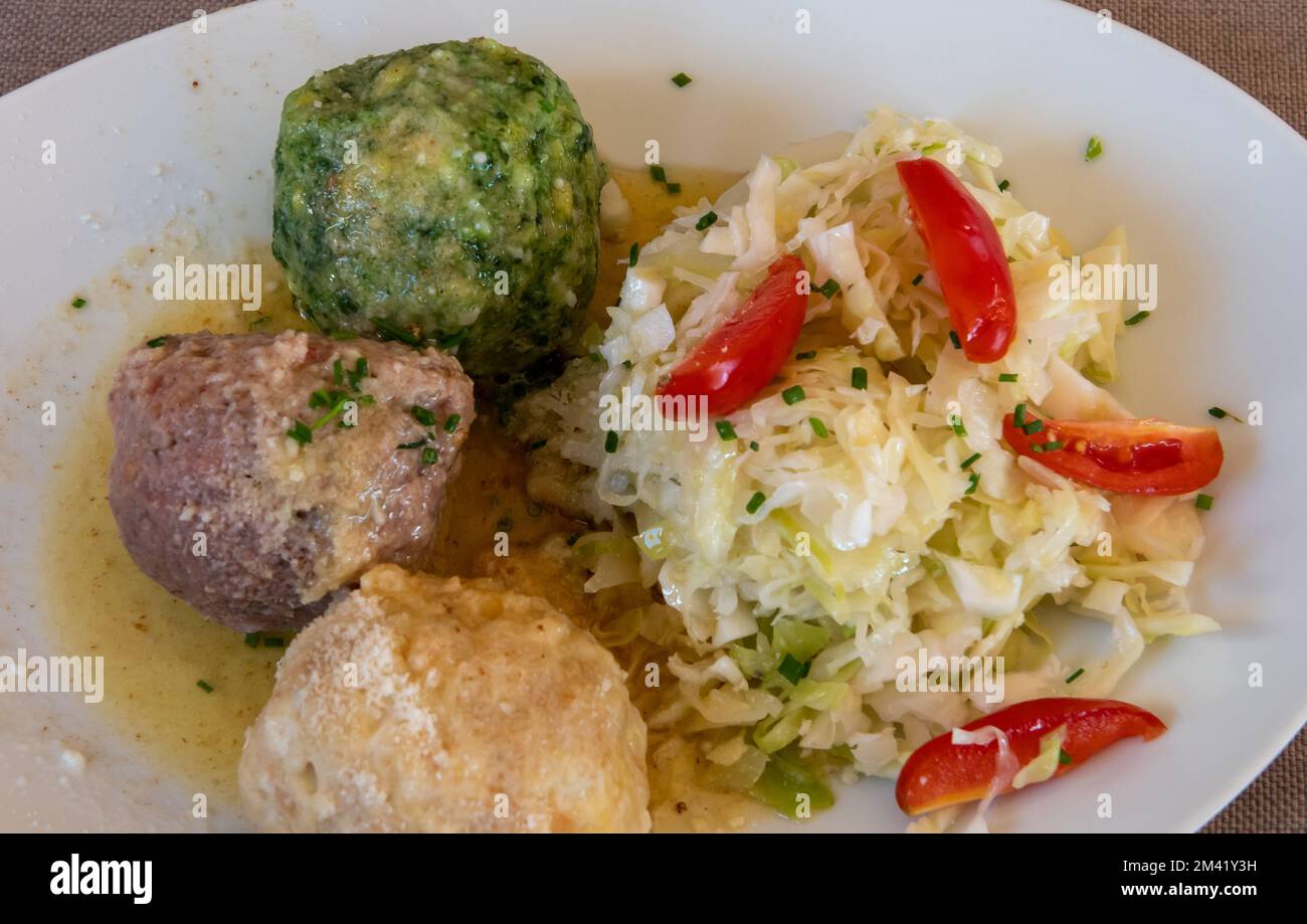Knödel or Canederli bread dumplings with cabbage, a typical speciality of Alto Adige or South Tyrol, Italy Stock Photo