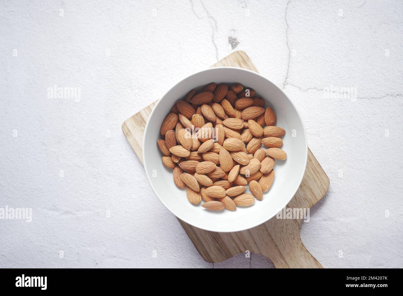 top view of almond nuts in a bowl on table  Stock Photo