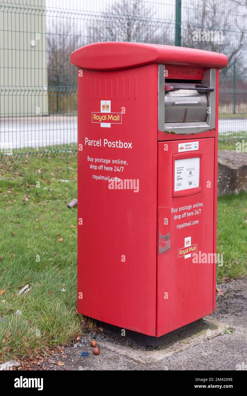 Royal Mail parcel delivery box taken on 15 Dec 2022 in Burnley Lancashire. Red postal collection box for parcels and franked mail Stock Photo