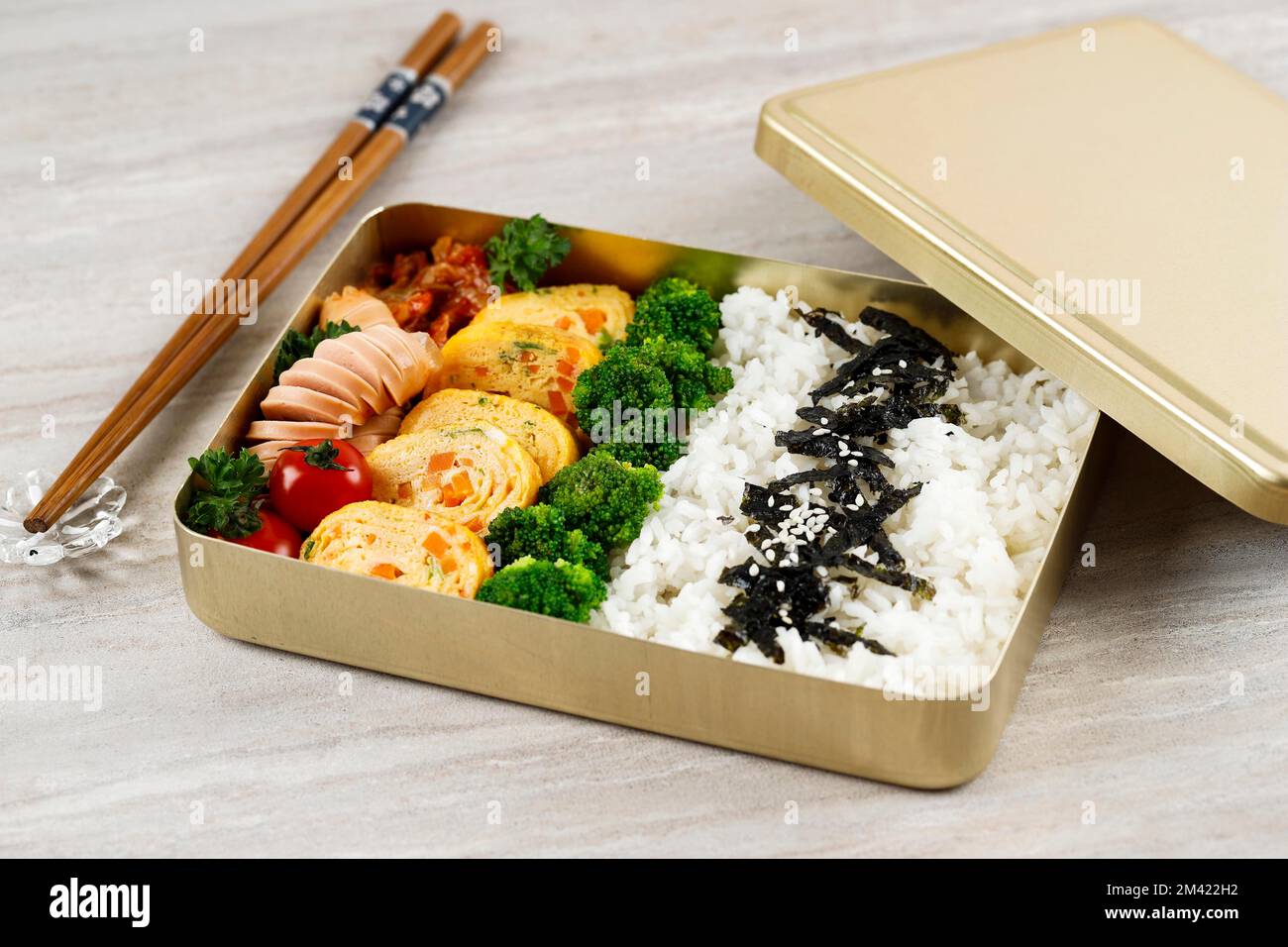 Dosirak, Korean Lunchbox Contains of Rice with Various Side Dish, Egg, Sausage, Steam Broccoli