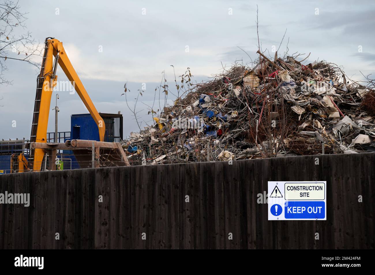 Scrap metal recycling compound viewed from boundary fence Stock Photo